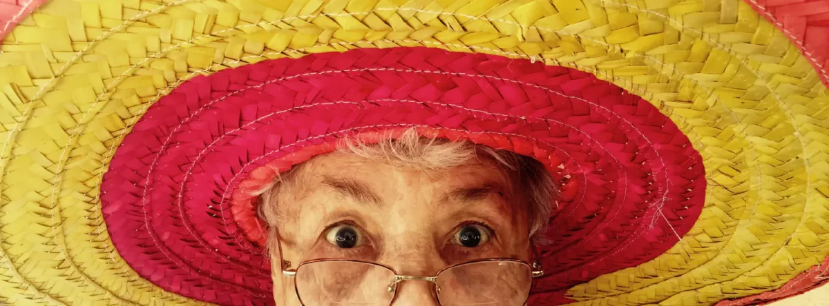 Woman in a large hat looking surprised