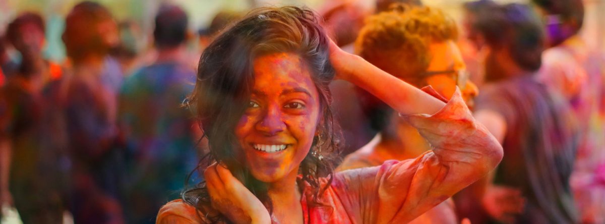 Smiling woman covered in paint at Holi Festival