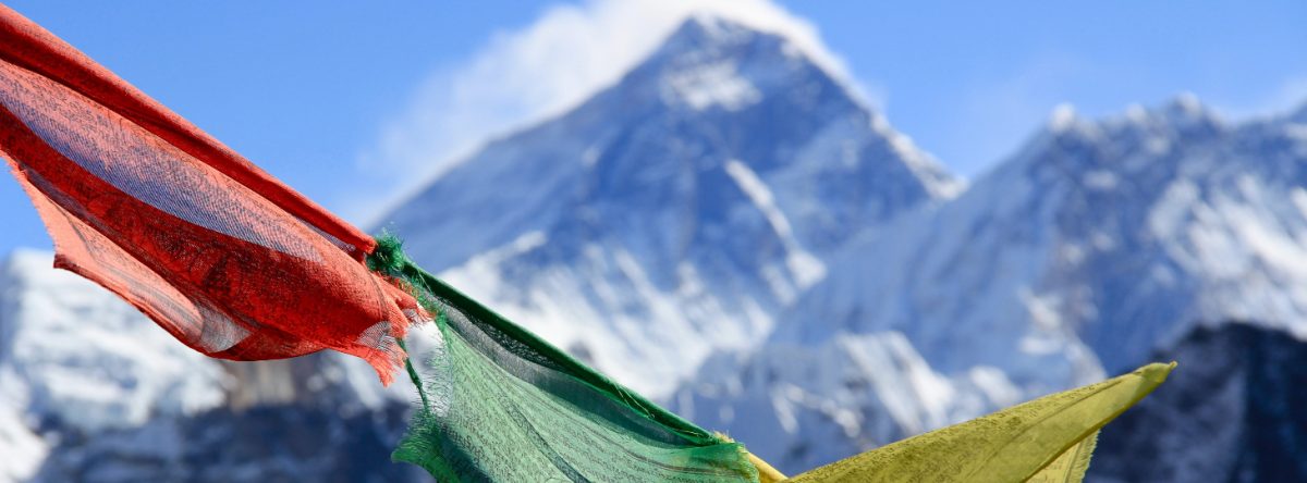 Prayer flags in front of Himalayan mountains